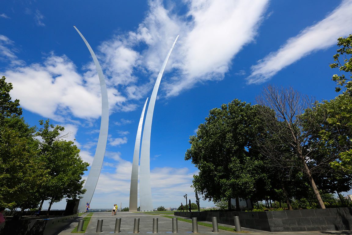 Sunrise DC view of the Air Force Memorial in Arlington, Virginia, with its striking spires illuminated against a vibrant morning sky.