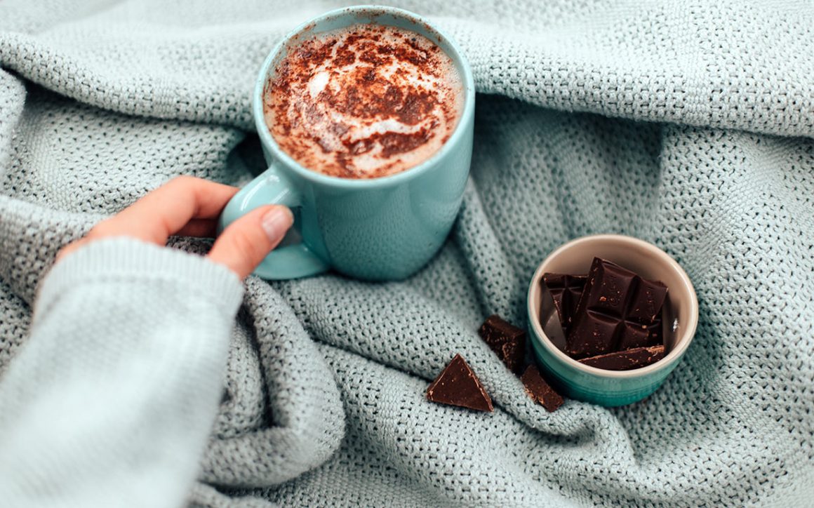 A hot chocolate mug, paired with a cup of rich, dark chocolate, sits invitingly. This enticing duo suggests a delightful find for anyone seeking the best hot chocolate near me or the best hot chocolate in DC.