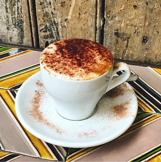 A warm white chocolate steamer, topped with a delicate swirl of foam, sits in a cup at Ebenezers Coffeehouse, offering a creamy, sweet alternative that stands out alongside what some consider the best hot chocolate near me or the best hot chocolate in dc.