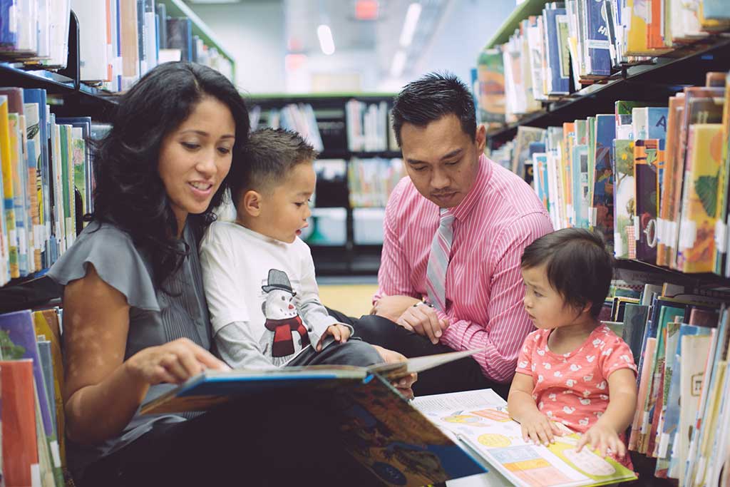 Family Reading at a DC Library: A family reading together at a cozy corner in a library, a relaxing activity and things tto do in DC with toddlers.