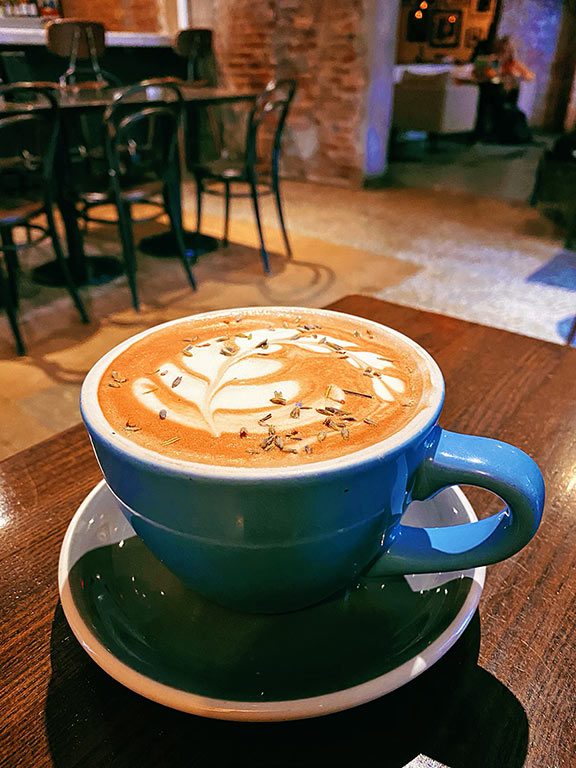 A beautiful hot chocolate with intricate fern coffee art graces a mug at The Emissary, making it a strong contender for the best hot chocolate near me or the best hot chocolate in dc.