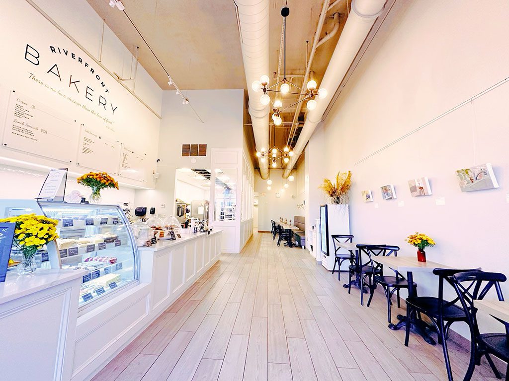Wilmington DE Coffee Shops - Cozy interior of Riverfront Bakery in Wilmington DE, featuring a counter with coffee and pastries.